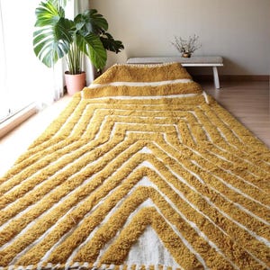 Yellow rug Handwoven rug Shaggy texture Moroccan style Geometric pattern Bohemian decor Cozy rug Soft texture Artisan rug Modern boho Statement piece Living room decor Bold design Striped rug Plush rug Warm tones Handmade rug Earthy colors Vintage