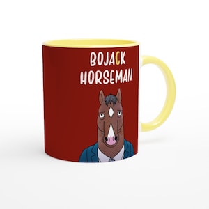 May include: A red ceramic mug with a yellow rim and handle. The mug features a cartoon image of Bojack Horseman, a brown horse with a blue suit and a white shirt, with the text "BOJACK HORSEMAN" in white letters.