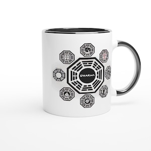 May include: White ceramic mug with a black rim and handle. The mug features a black and white graphic of the Dharma Initiative logo from the TV show Lost. The logo is surrounded by eight smaller symbols.