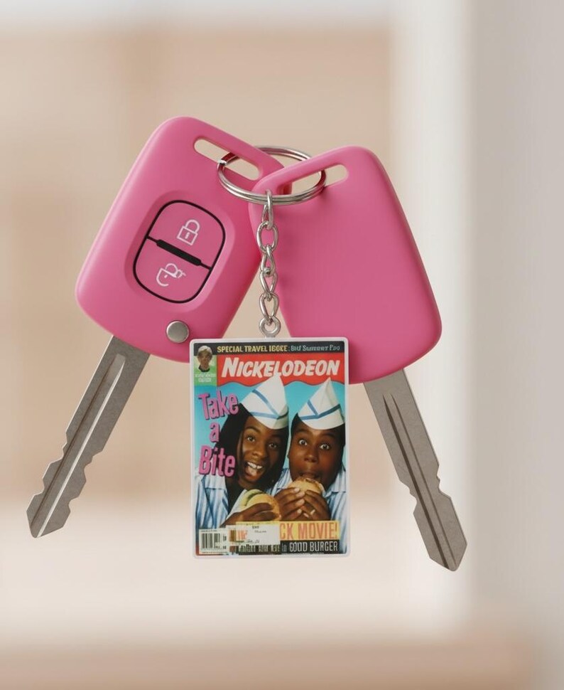 May include: Two pink car keys with a silver key ring and a small magazine-style charm. The charm features the Nickelodeon logo and the words "Take a Bite" with images of two people eating burgers.