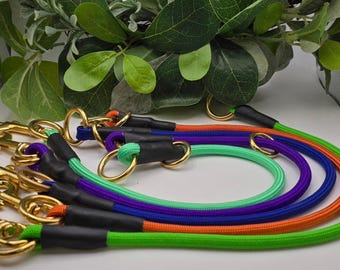 May include: Five colourful dog leads with gold metal clips. The leads are green, orange, purple, blue and black.