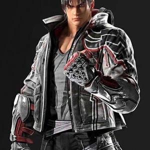 Può includere: Un personaggio di un videogioco indossa una giacca di pelle nera e grigia con dettagli rossi. La giacca ha un colletto alto e una chiusura a zip. Il personaggio indossa anche pantaloni neri e guanti con placche metalliche.