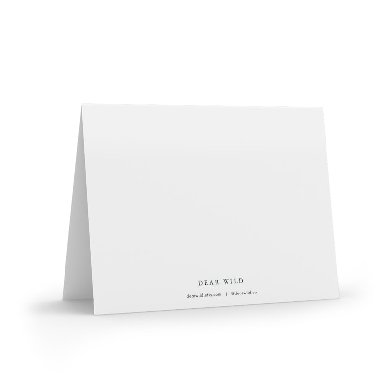 May include: Blank white card with the text "DEAR WILD" and the website address "dearwild.etsy.com" and the social media handle "@dearwild.co" printed on the bottom.