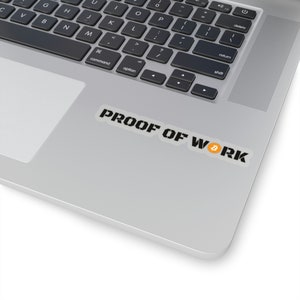May include: A rectangular sticker featuring the black text PROOF OF WORK in a bold, stencil-style font. The letter O in the word WORK is replaced by a small, circular orange and white Bitcoin symbol. The sticker is applied to a silver laptop surface.