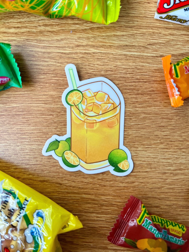 May include: A sticker of a glass of iced tea with a green straw and lime slices. The background is a wooden surface.