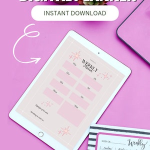 May include: A digital weekly planner displayed on a tablet, with a pink and white design. The tablet is on a pink surface, with text that reads "DIGITAL PLANNER" and "INSTANT DOWNLOAD". A printed planner is also visible.