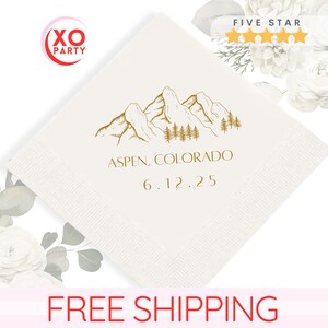 May include: White paper napkin with a gold mountain range design and the text "Aspen, Colorado" and "6.12.25".