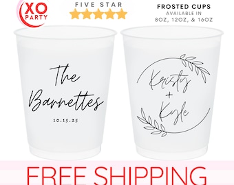 May include: Two white frosted cups with black text. The first cup says "The Barnettes" with the date "10.15.25" below. The second cup has a circle with leaves around it and the text "Kristy + Kyle" inside.