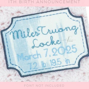 May include: A light blue embroidered birth announcement patch with the name "Miles Truong Locke", birth date March 7, 2025, and measurements 7.2 lbs and 19.5 inches. The patch has a decorative border and is stitched on a light blue and white striped background.