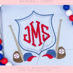 May include: Embroidered baseball crest design with the initials "JMS" in a red shield, two baseball bats, and two baseballs. The design is stitched on a light blue fabric. "Stitched by @simplyyoursky Font not included"