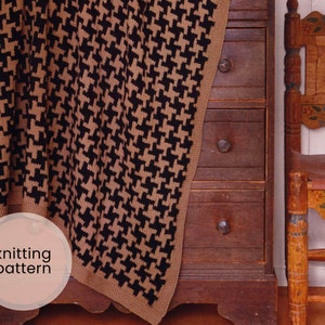May include: A black and brown houndstooth knit blanket draped over a wooden dresser with three drawers. The blanket has a fringe border and the text "knitting pattern" is written on a white circle.