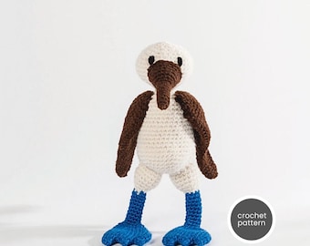 May include: Crocheted blue-footed booby amigurumi toy with brown head and white body. The toy is standing on a white surface. crochet pattern