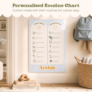 May include: A personalised routine chart with a blue and white striped design. The chart features illustrated daily tasks and the name "Archie" in gold. A backpack, basket, and books are also visible.