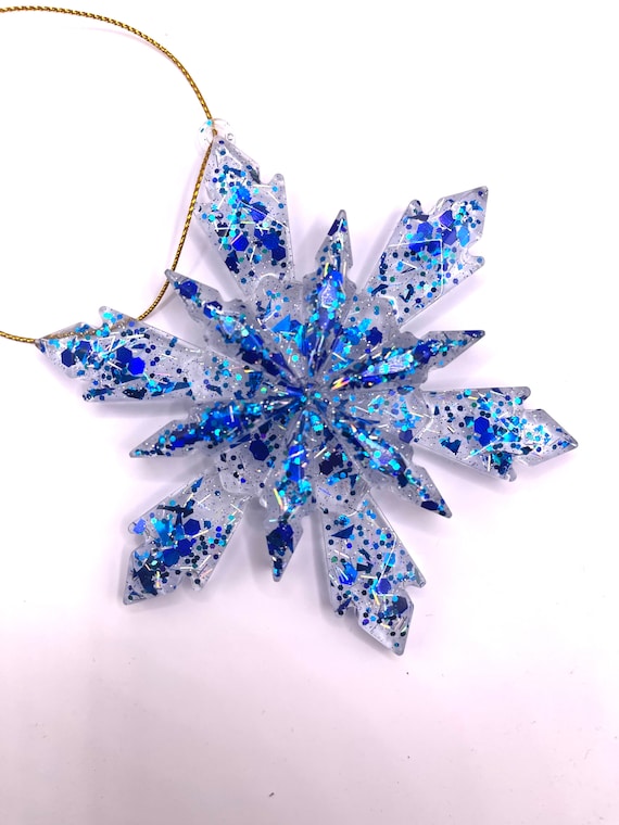 Snowflake Christmas ornament clear resin with blue accents and silver tensile.