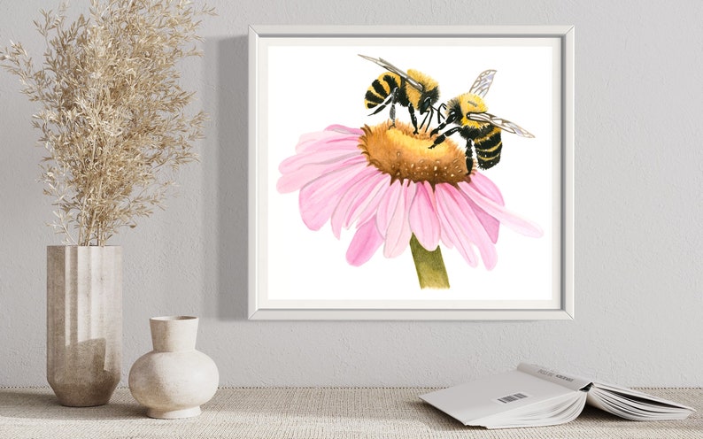 May include: Two yellow and black bumblebees pollinating a pink coneflower. The flower is in focus and the bees are slightly out of focus.