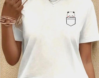 May include: White t-shirt with a small pocket design featuring a cartoon panda bear. The panda has black and white markings and is peeking out of the pocket. The shirt has short sleeves and a crew neck.
