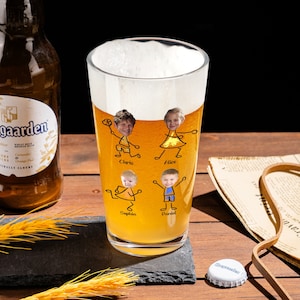May include: A tall clear glass beer mug with a yellow beverage inside. The mug has a personalized design with stick figure drawings of four people with their faces in the drawings. The names Chris, Alice, Sophia, and Daniel are written below the figures.