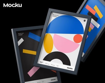 May include: Three framed art prints with geometric designs in blue, pink, yellow, and black. The frames are dark gray, and the prints feature the text "Boost your designs" and the Mocku logo. The background is black.