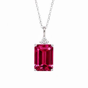 May include: A silver necklace featuring a rectangular, vibrant pink gemstone pendant. The pendant is accented with small, clear gemstones at the top. The chain is delicate and silver, creating a classic and elegant look.
