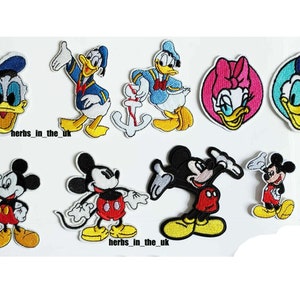 May include: Set of 9 embroidered iron-on patches featuring Mickey Mouse and Donald Duck characters. The patches are colourful and feature various poses of the characters.