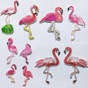 May include: A set of ten pink flamingo iron-on patches. The patches are embroidered with pink and white thread. The patches are ideal for adding a touch of whimsy to clothing, bags, or other fabric items.