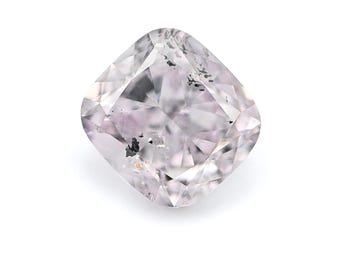 May include: A cushion-cut diamond with a pale pink hue. The gemstone has a square shape with rounded corners and facets that reflect light. Dark inclusions are visible within the stone, adding character to the gem.
