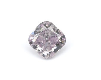 May include: A cushion-cut, light pink diamond with a high degree of clarity. The gemstone is set against a white background, showcasing its facets and internal structure. The diamond's shape is square with rounded corners.