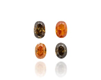 Puede incluir: Cuatro gemas ovaladas en tonos naranja, marrón y verde oliva se muestran sobre un fondo blanco. Las gemas están dispuestas en una formación cuadrada, reflejando la luz y mostrando su color y claridad únicos.