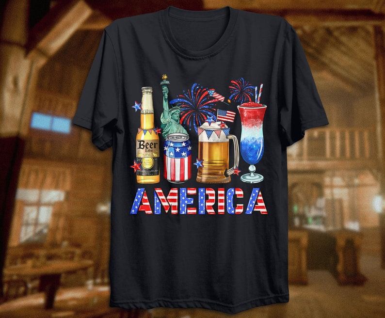 May include: A black t-shirt with a graphic of a beer bottle, a can of beer, a glass of beer, a glass of red, white, and blue cocktail, and fireworks. The text "AMERICA" is printed in red, white, and blue letters below the graphic.