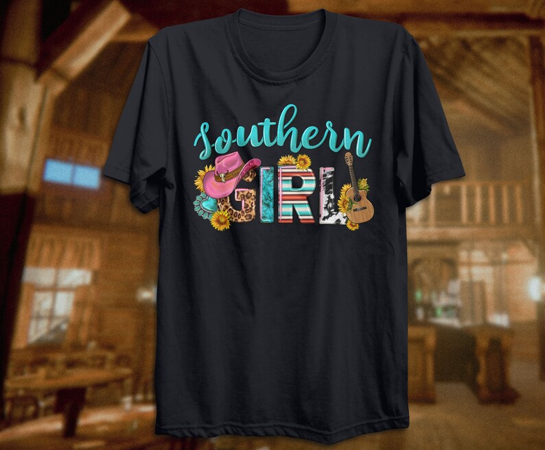 May include: Black t-shirt with the text "Southern Girl" in turquoise lettering. The text is decorated with a pink cowboy hat, a guitar, sunflowers, and a cow print.
