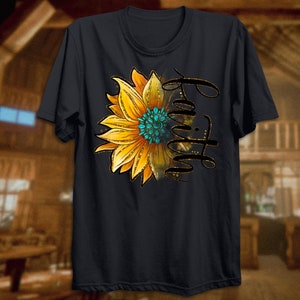 K&ouml;nnte beinhalten: Schwarzes T-Shirt mit einem Sonnenblumen-Motiv und dem Wort "Glaube" in goldenen Glitzerbuchstaben.