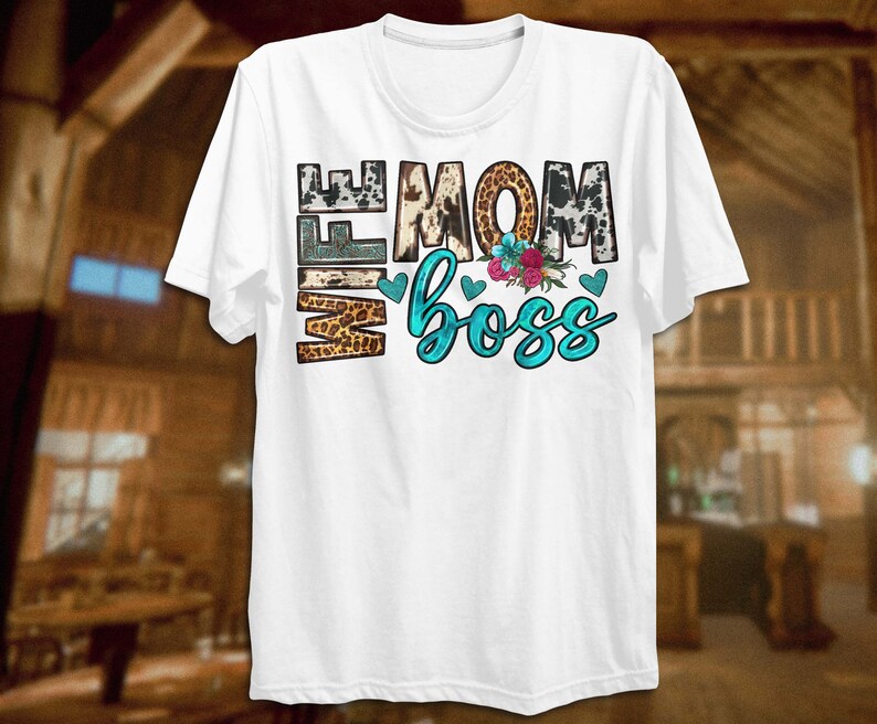 May include: White t-shirt with the text "Wife Mom Boss" in turquoise blue letters with a cowhide, leopard print, and floral design.