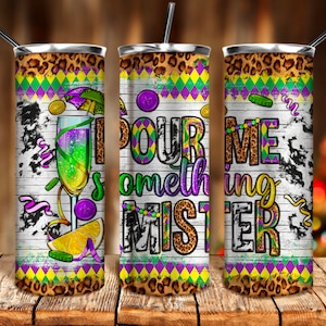 May include: Three stainless steel tumblers with a Mardi Gras theme. The tumblers feature a white background with a leopard print pattern, green, purple and gold accents, and the text "Pour Me Something Mister".