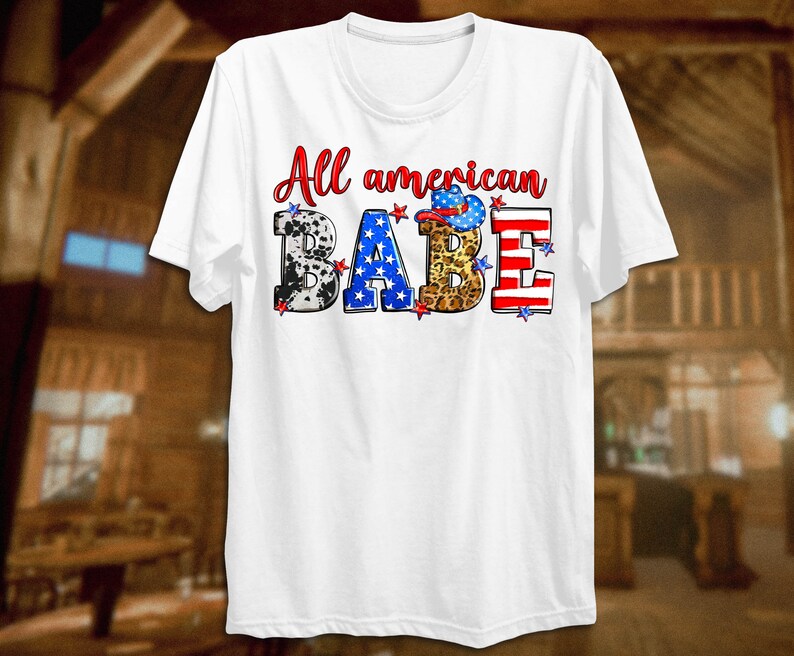 May include: White t-shirt with the text "All American Babe" in red, blue, and white letters. The letters are decorated with stars, cow print, leopard print, and an American flag.