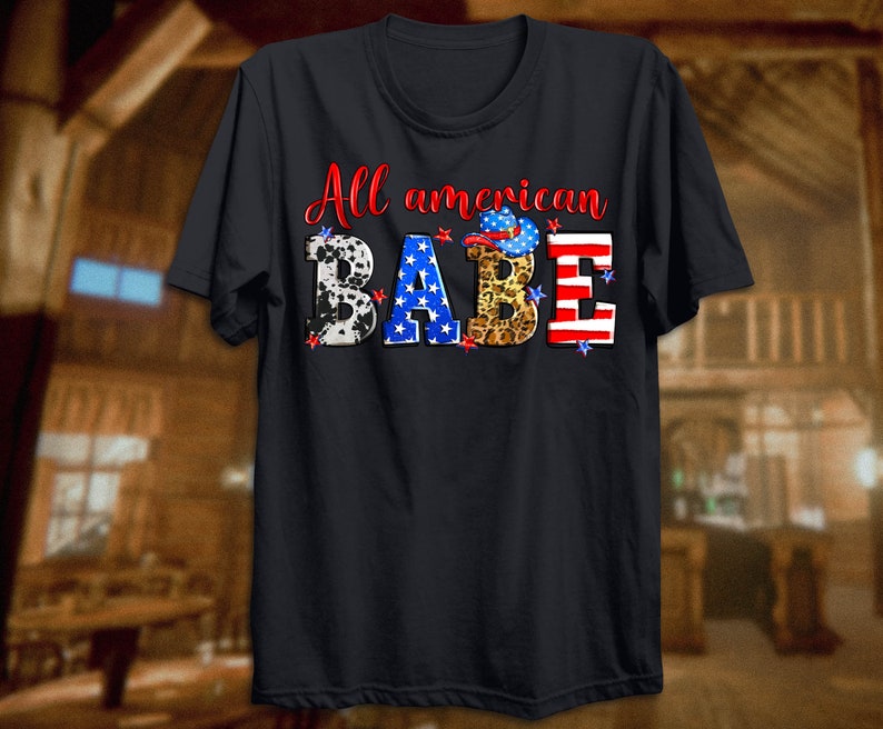 May include: A black t-shirt with the text "All American Babe" in white. The letters are decorated with red, white, and blue stars, cow print, leopard print, and a cowboy hat.