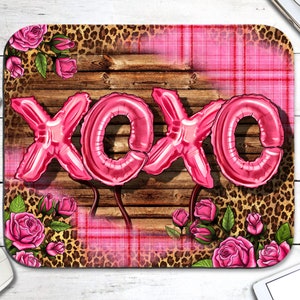 May include: Pink XOXO balloons on a brown wood background with a pink and white plaid pattern and leopard print.
