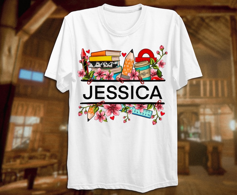 May include: White t-shirt with a colorful design of books, pencils, a ruler, a coffee cup, and flowers. The name "JESSICA" is printed in black letters on the shirt.