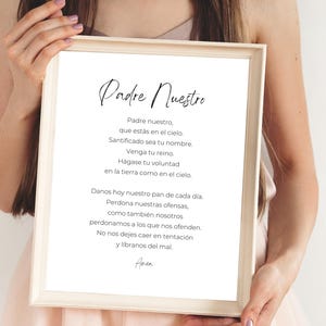 May include: A framed print with the text "Padre Nuestro" and the Lord's Prayer in Spanish. The text is printed in black ink on a white background.