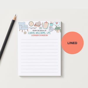 May include: A white lined notepad with a decorative top border featuring a light blue armchair, clock, books, and coffee cup. The notepad includes the text "FROM THE DESK OF: CAROL WILLIAMS, LPC LICENSED COUNSELOR" and a coral-colored circle that says "LINED".