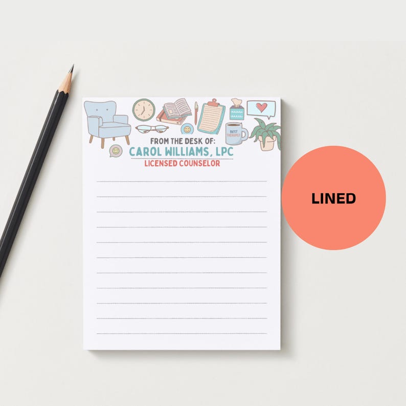 May include: A white lined notepad with a decorative top border featuring a light blue armchair, clock, books, and coffee cup. The notepad includes the text "FROM THE DESK OF: CAROL WILLIAMS, LPC LICENSED COUNSELOR" and a coral-colored circle that says "LINED".