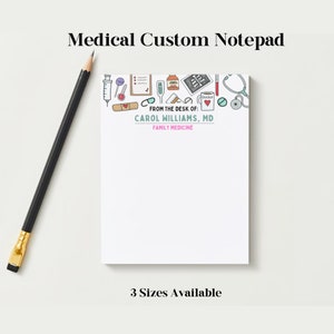 May include: A white notepad with a blue border and a variety of medical-themed illustrations. The notepad has the text "FROM THE DESK OF: CAROL WILLIAMS, MD FAMILY MEDICINE" printed on it. The notepad is available in three sizes.