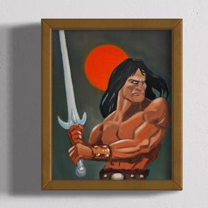 May include: A framed painting depicting a muscular figure with long dark hair holding a silver sword. The background features a dark gray sky and a large, vibrant orange sun. The figure wears a brown wrist cuff and a dark belt, rendered in a comic style.