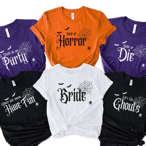 Group of 6 Halloween bachelorette shirts with gothic font phrases of "Bride", "Maid of Horror", "Let's Go Ghouls", Ghouls Just wanna have fun", Till Death do we Party", and "Bride or Die", with a spider web with a hanging spider and bats surrounding the font, perfect spooky matching bridal party shirts.