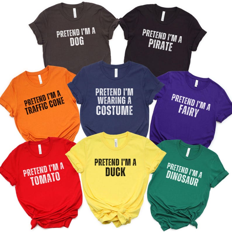 Eight Halloween-themed t-shirts in various colors, including brown, black, orange, red, yellow, green, purple, and navy blue. Each shirt features a different text 'Pretend I'm a...' followed by the costume name, such as ‘Dog’, ‘Pirate’, ‘Traffic Cone’, ‘Fairy’, ‘Tomato’, ‘Duck’, ‘Dinosaur’, or the simple ‘Pretend I’m Wearing a Costume’.  The shirts are made of soft, comfortable material and are perfect for Halloween parties or costume events.