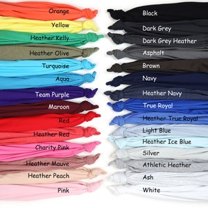 May include: A color chart of 20 different t-shirt colors, including orange, yellow, heather kelly, heather olive, turquoise, aqua, team purple, maroon, red, heather red, charity pink, heather mauve, heather peach, pink, black, dark grey, dark grey heather, asphalt, brown, navy, heather navy, true royal, heather true royal, light blue, heather ice blue, silver, athletic heather, ash, and white.