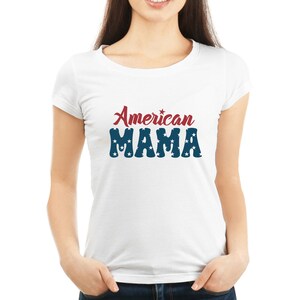 May include: White t-shirt with the text "American MAMA" in red and blue. The word "American" is in a script font, and "MAMA" is in a bold font with white stars.