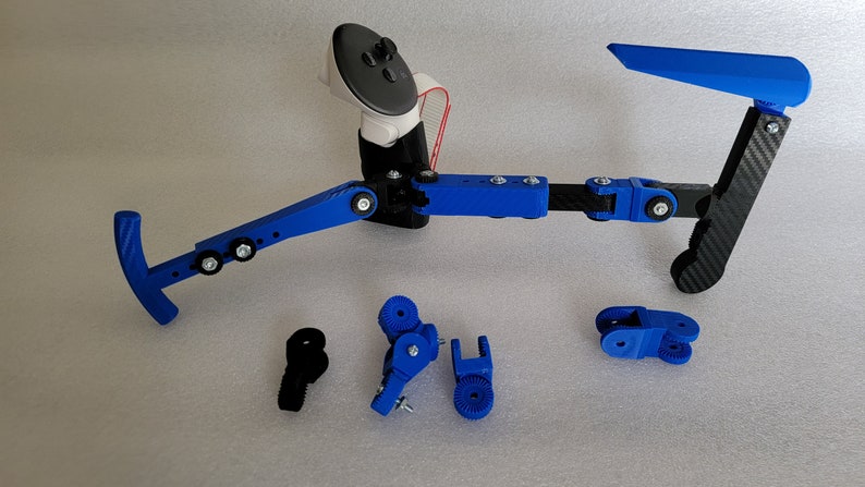 May include: A blue and black 3D printed device with multiple joints and a handle. The device is designed to hold a phone or other device. There are several spare parts for the device, including a blue handle and a blue joint.