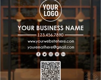 May include: A square business sign featuring a white circular logo placeholder, the text YOUR BUSINESS NAME, a phone number 123.456.7890, a website URL, an email address, social media icons, and a central QR code on a dark, blurred background.