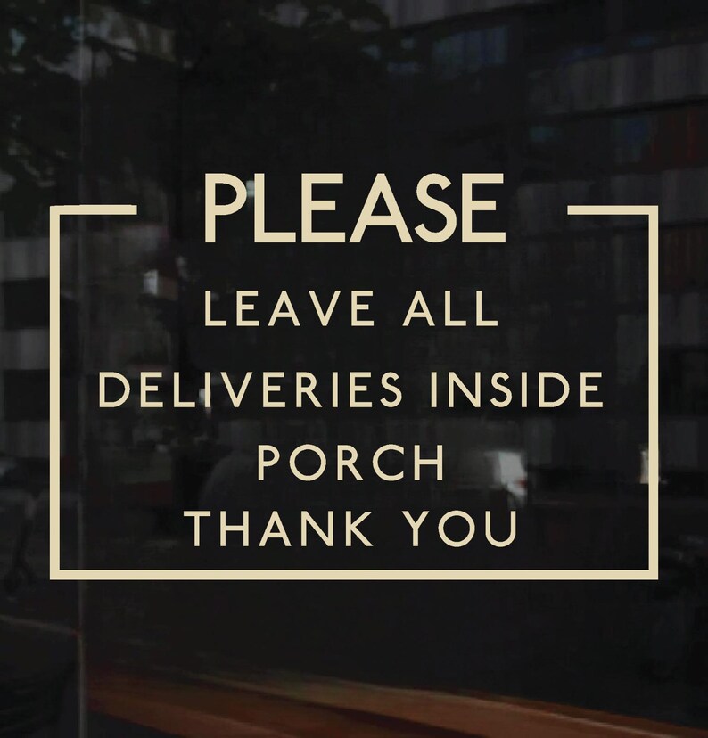 A dark-colored sign with beige text that reads: PLEASE LEAVE ALL DELIVERIES INSIDE PORCH THANK YOU. The text is enclosed in a beige rectangular border.
