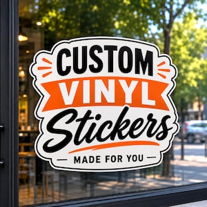 May include: A white vinyl sticker with a scalloped edge applied to a glass surface. The sticker features the black text CUSTOM, a central orange banner with the white text VINYL, the black script text Stickers, and the text MADE FOR YOU.